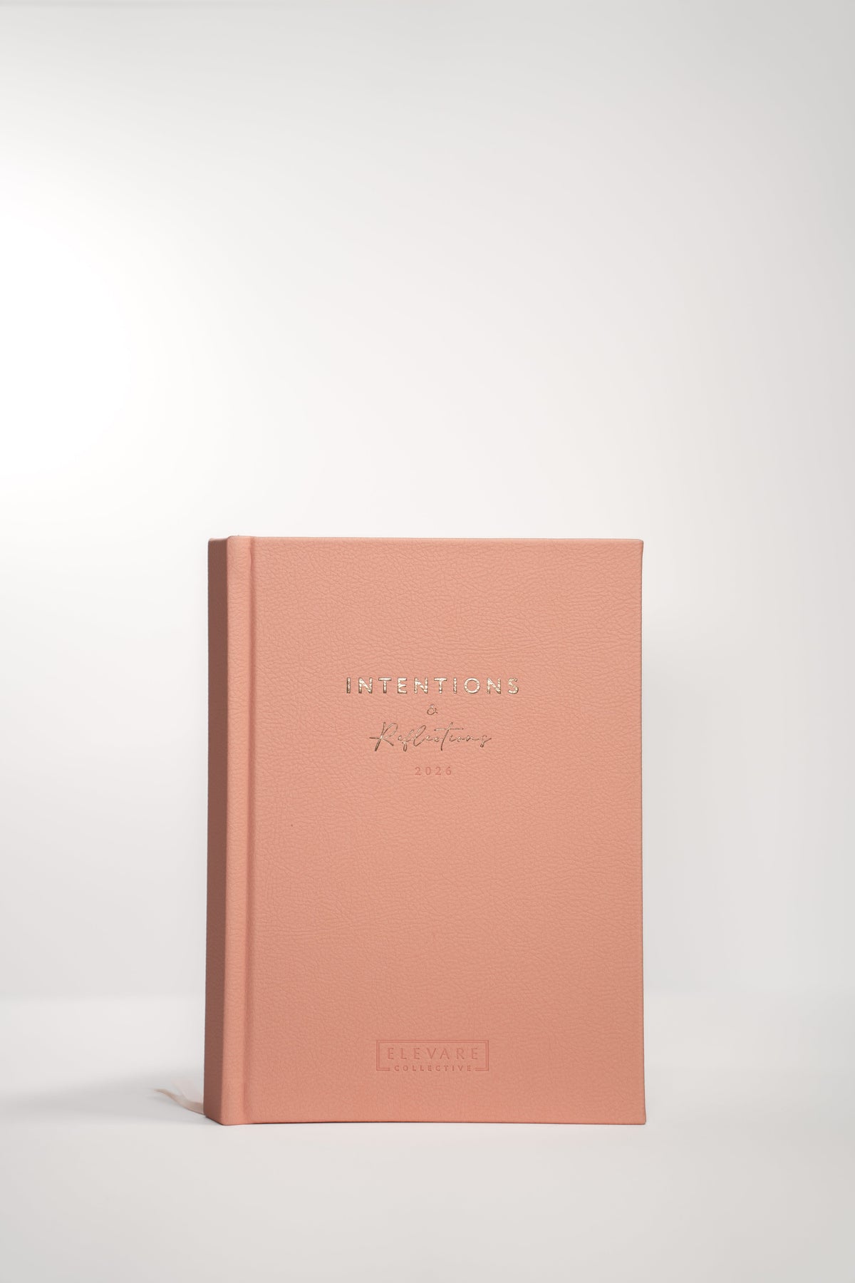 Rose Quartz Intentions and Reflections journal, closed, styled on a desk