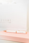 Elevare Collective Signature Gel Pen — styled with journal on desk